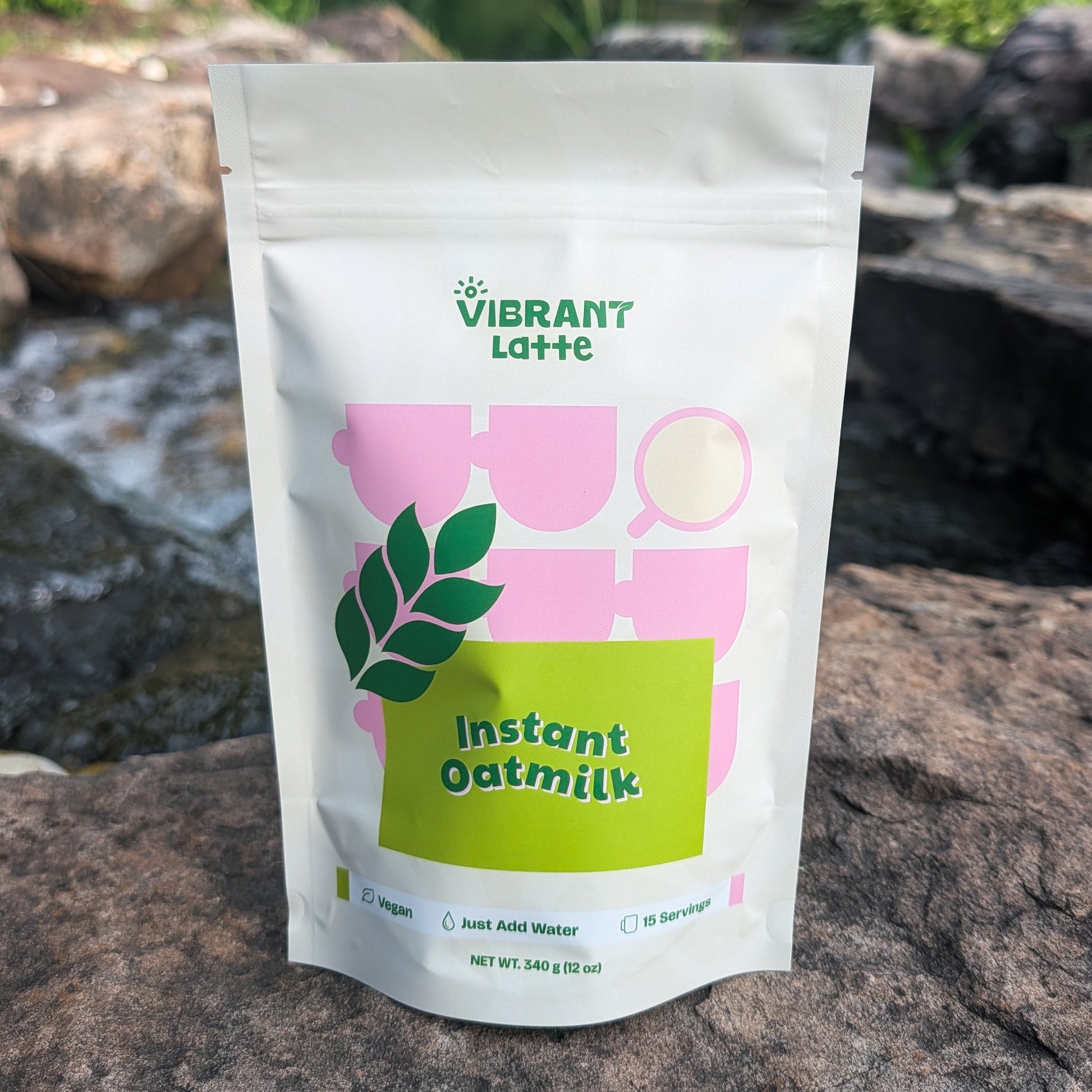 Vibrant Latte instant oatmilk package on a rock with a natural background